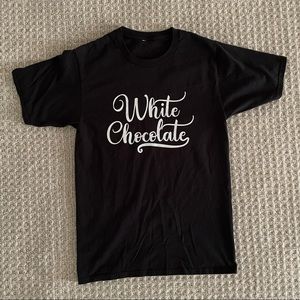 Unisex (adult small) Black T-shirt with “White Chocolate” in white writing.